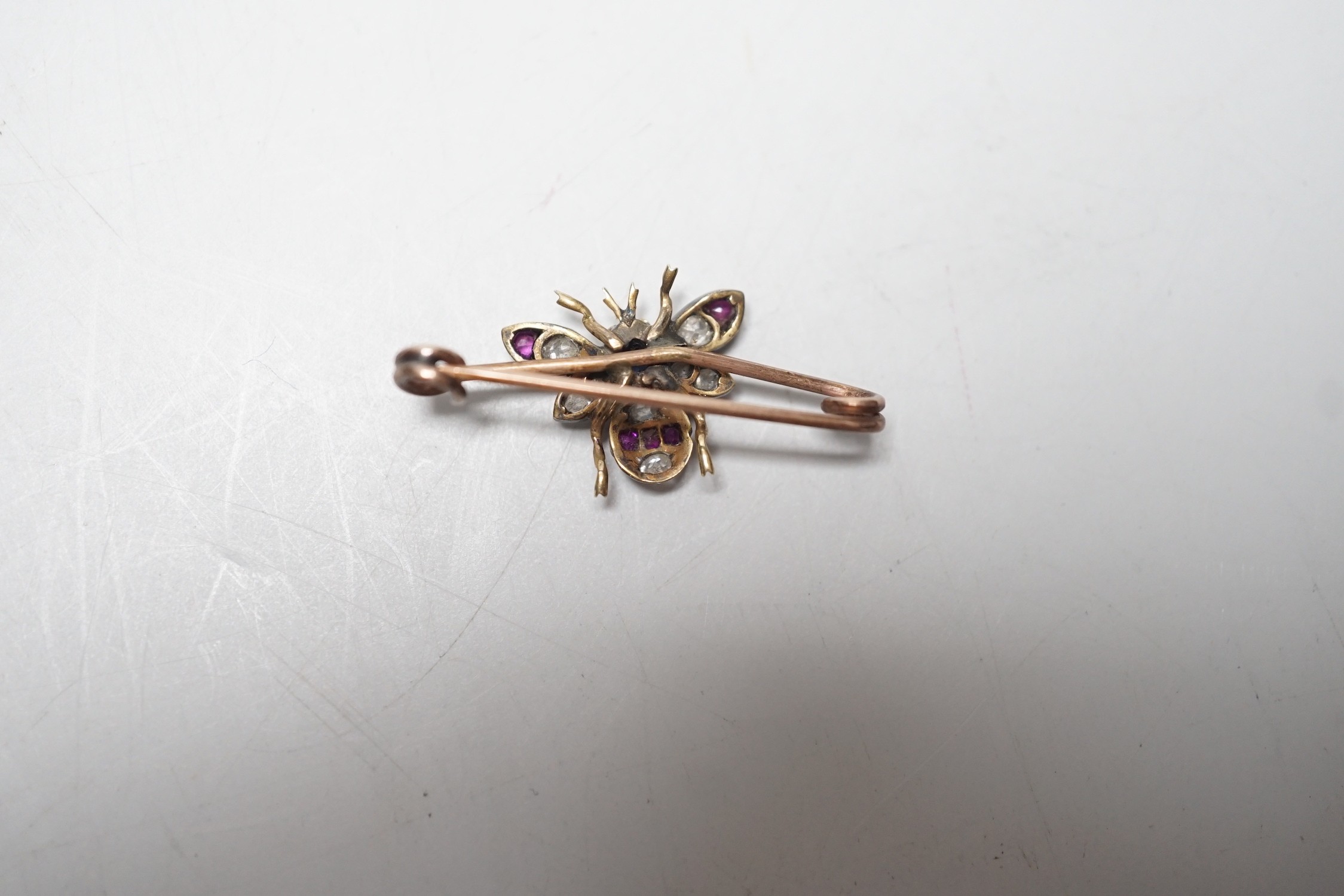 A late Victorian yellow metal, ruby, sapphire and diamond set bug brooch, 30mm, gross weight 2.2 grams.